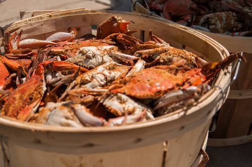 Baskets filled with freshly cooked crabs, showcasing their vibrant orange and red shells.
