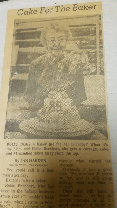 A newspaper clipping about Helen Bernhart's 85th birthday celebration with a cake and corsage.