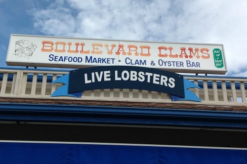 Sign for Boulevard Clams featuring "Live Lobsters" and information about the seafood market and oyster bar.
