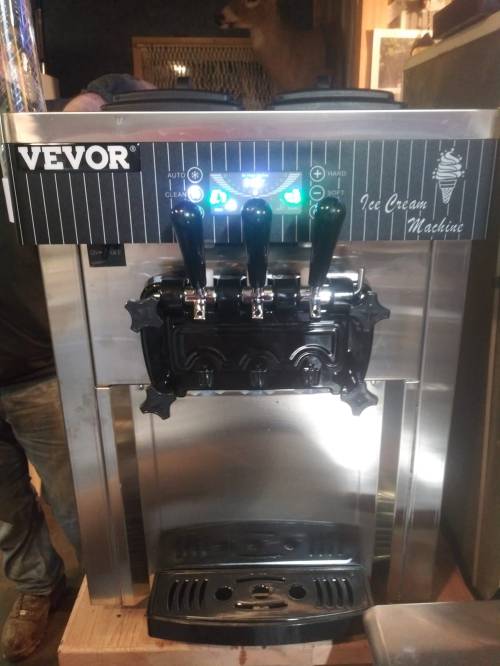 A stainless steel ice cream machine with three dispensing levers and control panel, labeled "VEVOR Ice Cream Machine."