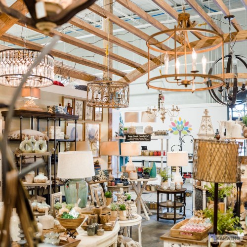 A cozy home decor store filled with various lighting fixtures, tables, and decorative items in a warm, inviting atmosphere.