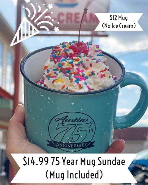 A hand holding a teal mug filled with a sundae topped with whipped cream, sprinkles, and a cherry, celebrating Austin's 75th anniversary.