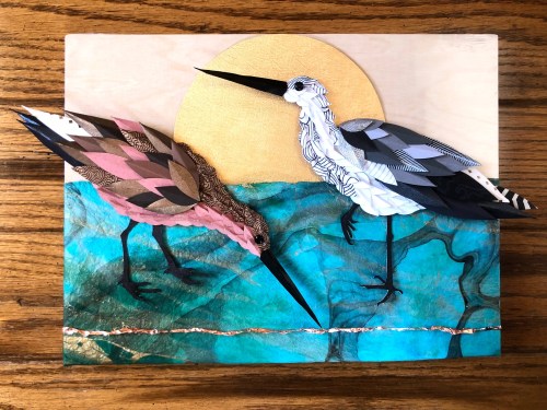Two stylized birds stand on a vibrant blue background with a golden sun, showcasing intricate paper textures and patterns.