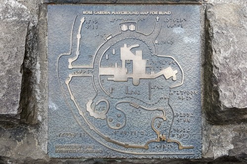 Bronze map of Rose Garden Playground, designed for the visually impaired, featuring tactile paths and landmarks.