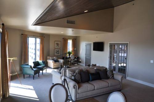 Spacious living room with modern furniture, large windows, and a telescope, featuring a cozy and inviting atmosphere.