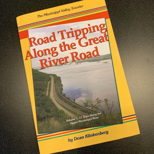 Book cover titled "Road Tripping Along the Great River Road" featuring a scenic view of the Mississippi River.