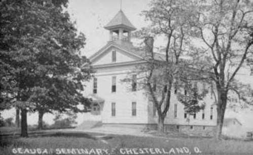 Historic black-and-white photo of Geauga Seminary in Chesterland, Ohio, surrounded by trees.