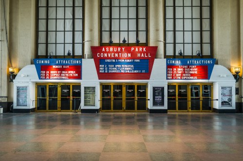 Exterior of Asbury Park Convention Hall with marquee displaying upcoming events and attractions.