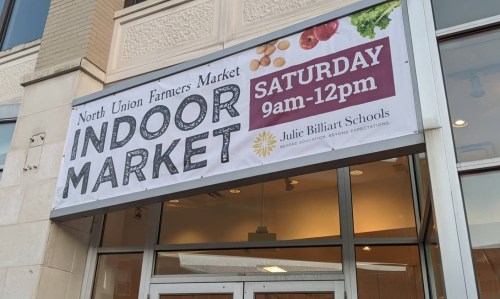Sign for the North Union Farmers Market, featuring "Indoor Market" and details for Saturday hours, 9am-12pm.