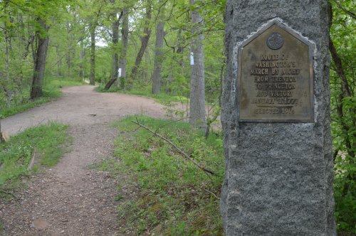 A stone marker along a wooded path, commemorating Washington's march route to Princeton, erected in 1914.