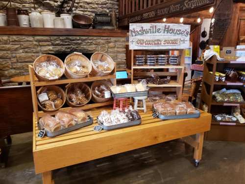 A rustic display of baked goods in wooden baskets and trays at Nashville House's Country Store.