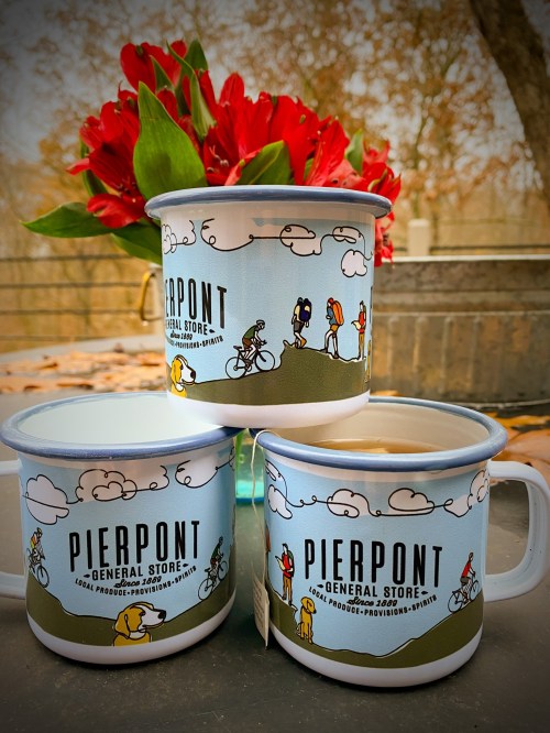 Three colorful mugs from Pierpont General Store, featuring playful illustrations and a backdrop of flowers.