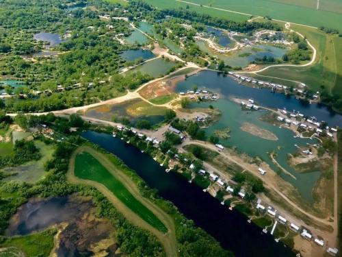 Aerial view of a lush landscape with winding waterways, small islands, and clusters of houses along the shore.