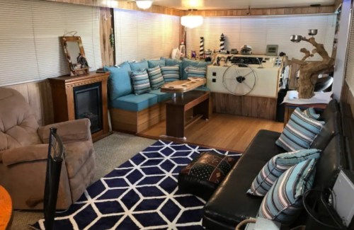 Cozy interior of a living space featuring a sectional sofa, coffee table, and decorative rug. Warm, inviting atmosphere.