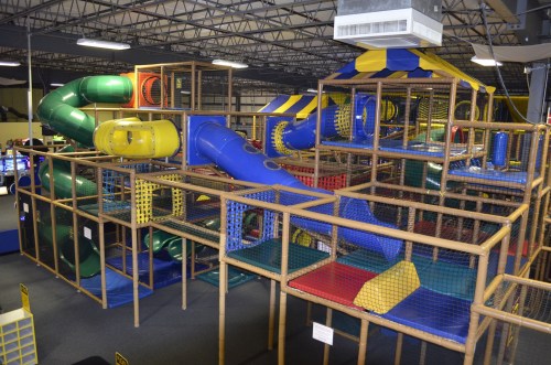 Colorful indoor playground with slides, tunnels, and climbing structures, designed for children's play and exploration.