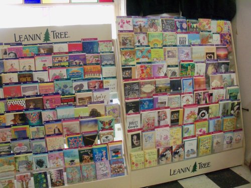 Two display stands filled with colorful greeting cards from Leanin' Tree, featuring various designs and messages.