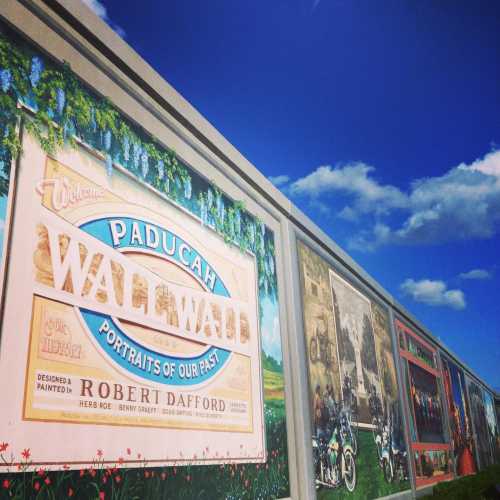 Mural titled "Paducah Wall to Wall," featuring colorful portraits and historical scenes, designed by Robert Dafford.