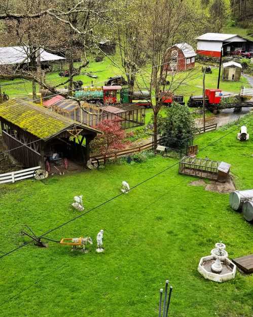 A scenic view of a farm with green grass, barns, and a train passing through the landscape. Statues and structures are visible.