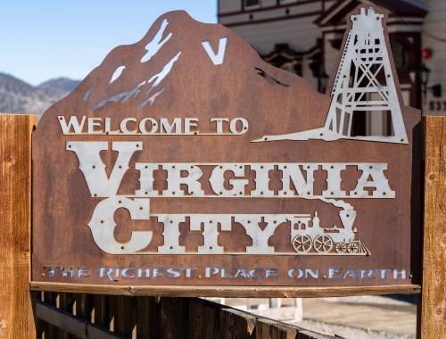 Sign welcoming visitors to Virginia City, featuring a mountain silhouette and the phrase "The Richest Place on Earth."