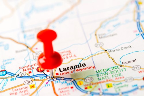 A close-up of a map showing Laramie, Wyoming, with a red pushpin marking the location.