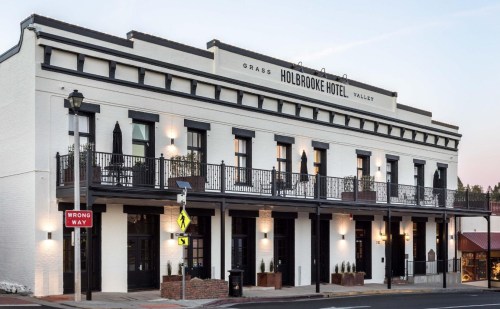 Historic Holbrooke Hotel with a classic facade, featuring balconies and street signage in the foreground.