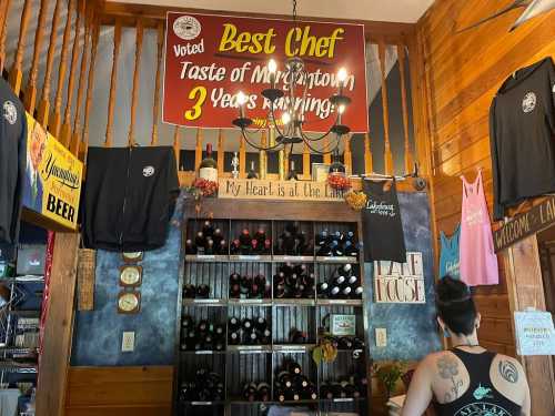 Interior of a cozy restaurant featuring a "Best Chef" sign, wine display, and various apparel hanging on the walls.