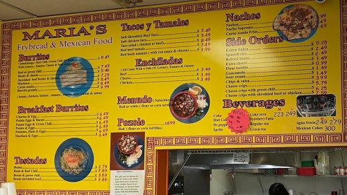 Menu board at Maria's featuring various Mexican food items like burritos, tacos, nachos, and beverages with prices.