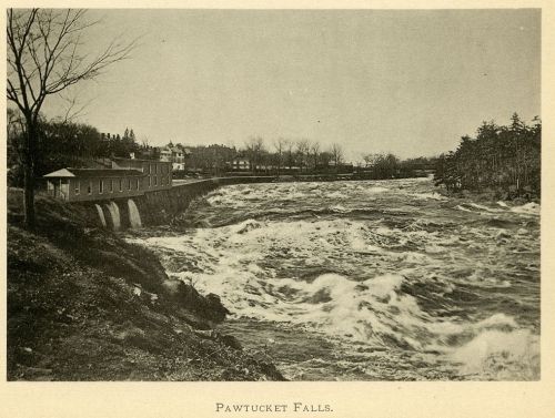 Black and white image of Pawtucket Falls, featuring rushing water and a nearby building along the riverbank.