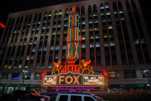 The illuminated Fox Theatre marquee at night, featuring vibrant neon lights and decorative architectural details.