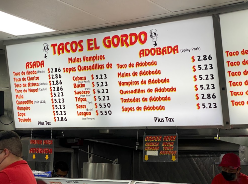 Menu board at Tacos El Gordo featuring various taco options and prices, including Asada and Adobada dishes.