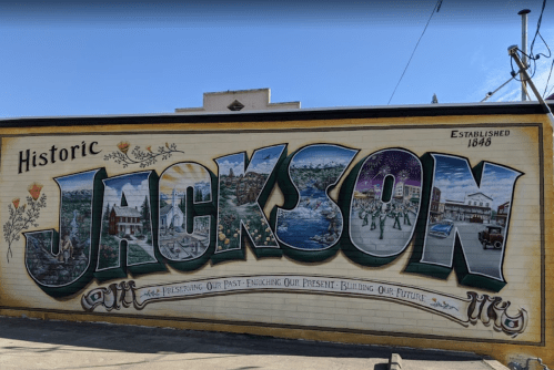 Colorful mural reading "Historic Jackson" with images representing the town's history and culture. Established 1846.