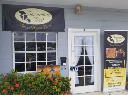 Signage for "Generations Best" featuring sweet potato pie, with an open sign and a display of baked goods outside.