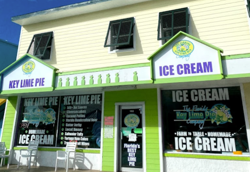 Bright storefront of "Key Lime Pie Company" featuring ice cream and key lime pie signage, with a green and white color scheme.