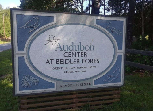 Sign for the Audubon Center at Beidler Forest, with hours of operation and a note about being smoke-free.