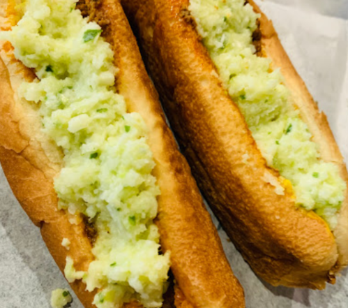 Two toasted bread rolls filled with a creamy, greenish potato mixture.
