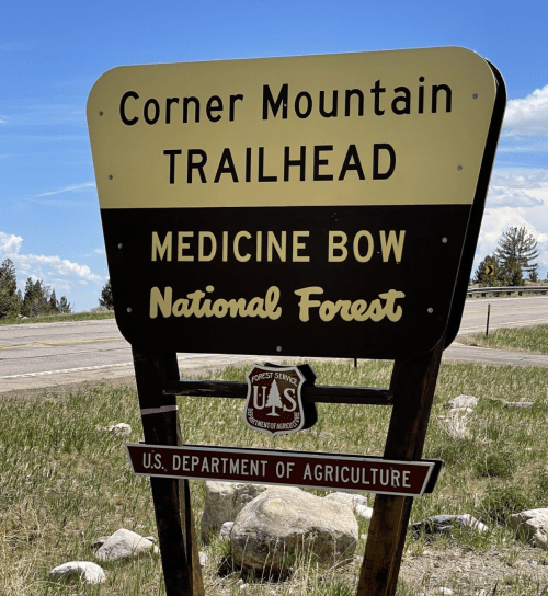 Sign for Corner Mountain Trailhead in Medicine Bow National Forest, featuring the U.S. Department of Agriculture logo.