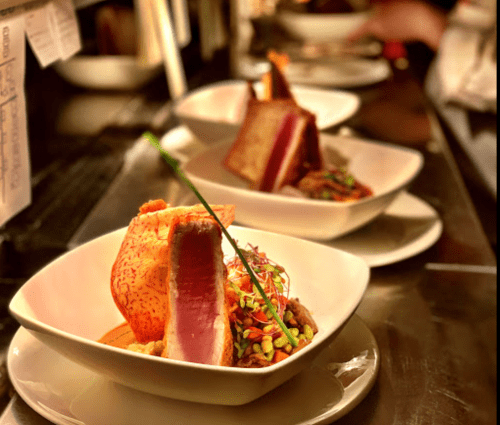 Three elegant dishes featuring seared tuna, colorful salad, and crispy garnish, presented in white bowls.