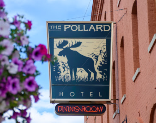Sign for The Pollard Hotel featuring a moose silhouette, with a floral backdrop and a "Dining Room" sign below.