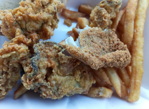 A plate of crispy fried fish pieces and golden French fries.