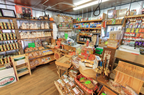 A cozy, well-stocked general store filled with shelves of snacks, baked goods, and various grocery items.