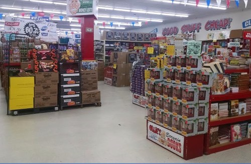 A colorful store aisle filled with various products, including boxes, books, and promotional signs.
