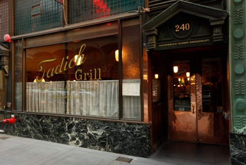Exterior of Tadich Grill, California's oldest restaurant, featuring a vintage sign and elegant entrance.