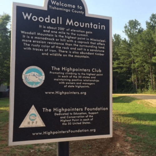 Sign for Woodall Mountain in Tishomingo County, Mississippi, detailing its elevation and the Highpointers Club.