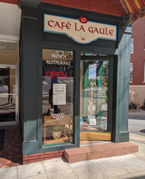 Exterior of Café La Gaule, a French restaurant with an "OPEN" sign and a welcoming entrance.