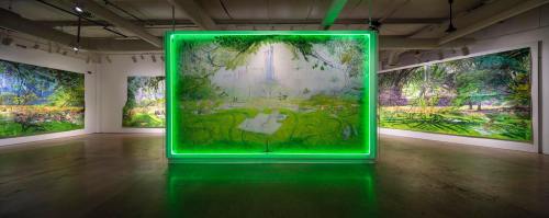 A vibrant art gallery featuring large, colorful nature-themed paintings and a glowing green frame in the center.