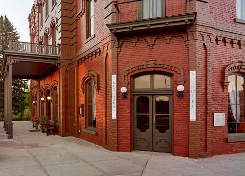 Historic red brick hotel exterior with restaurant signage and decorative windows.