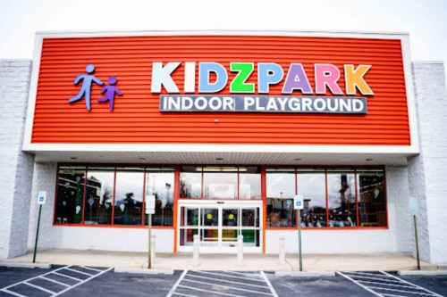 Exterior of KidzPark Indoor Playground, featuring colorful signage and a welcoming entrance.