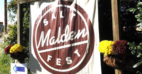Sign for "Salt Malden Fest" with decorative flowers on either side and an arrow pointing left.