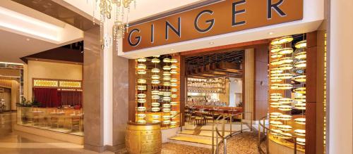 Entrance to a restaurant named "Ginger," featuring warm lighting and elegant decor.