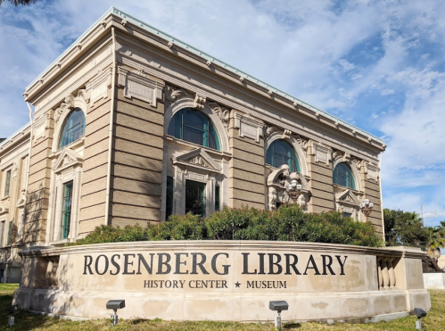 Exterior view of the Rosenberg Library, featuring classical architecture and a sign indicating its history center and museum.